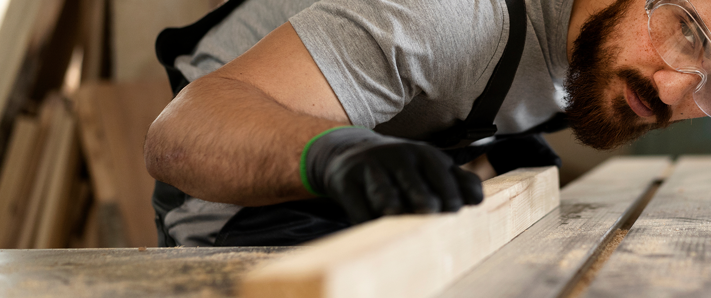 carpenter-cutting-mdf-board-inside-workshop 1.png